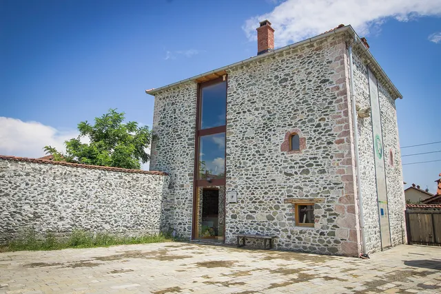 A tall stone kulla with small upper windows at Junik.