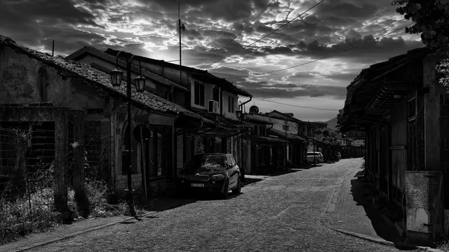 The Çarshia bazaar street at dusk — timber-fronted shops along the cobbles.