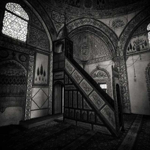 The painted interior — the carved wooden minber and walls of calligraphy.