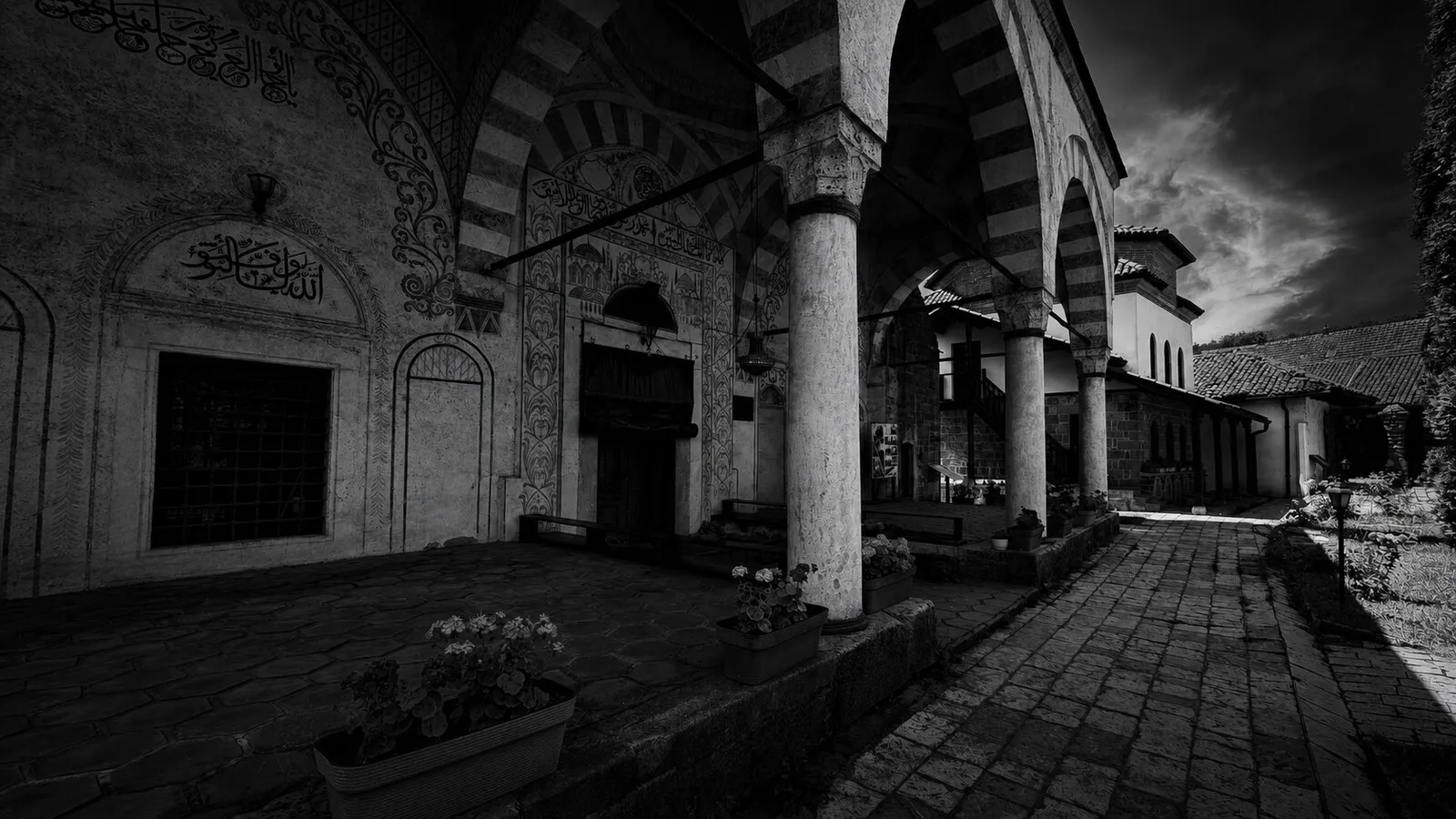 The Hadum Mosque's decorated portico — striped arches, carved ornament and calligraphy framing the entrance.
